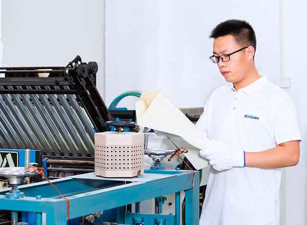 a worker in Kinbake uniform is inspecting mass production