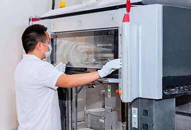 a male worker is operating a printing machine