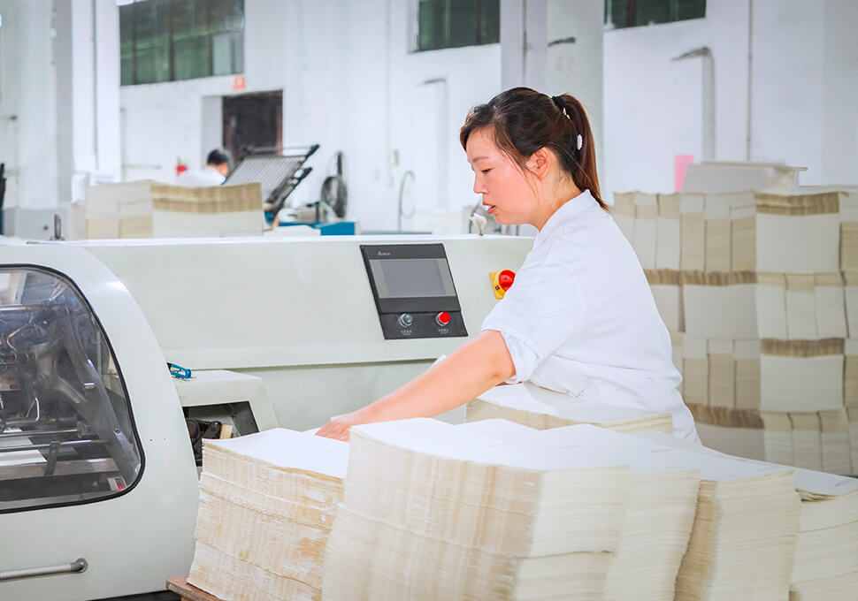 a female worker is operating inner page binding